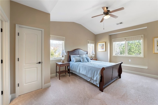 carpeted bedroom with ceiling fan, lofted ceiling, and multiple windows