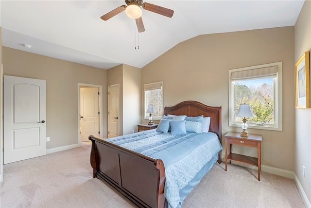 bedroom with vaulted ceiling, light carpet, and ceiling fan