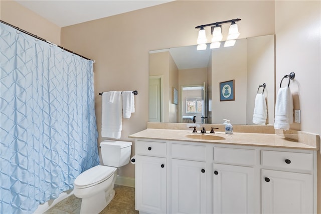 bathroom with tile patterned floors, a shower with curtain, vanity, and toilet