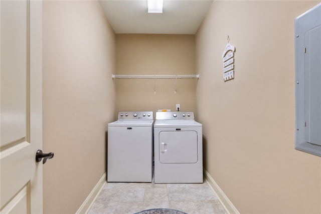 laundry room with light tile patterned flooring and washing machine and clothes dryer