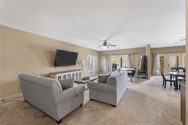 living room with ceiling fan, light carpet, and french doors