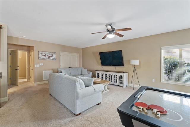 living room with ceiling fan and light colored carpet