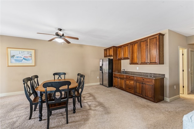 carpeted dining space featuring ceiling fan