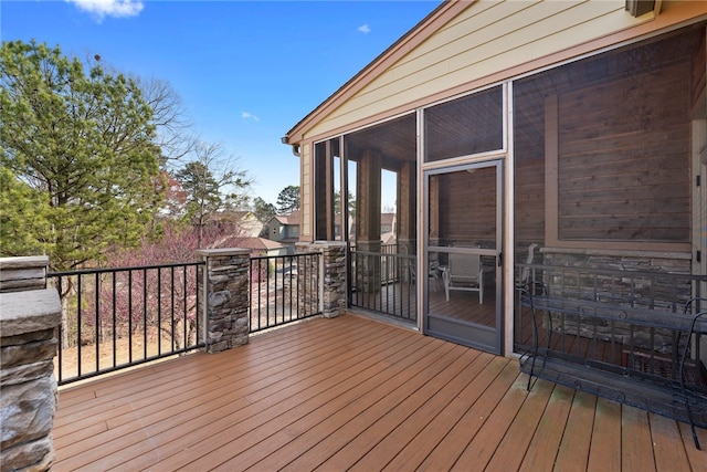 wooden deck featuring a sunroom