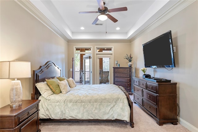 bedroom with a tray ceiling, access to exterior, light colored carpet, crown molding, and ceiling fan