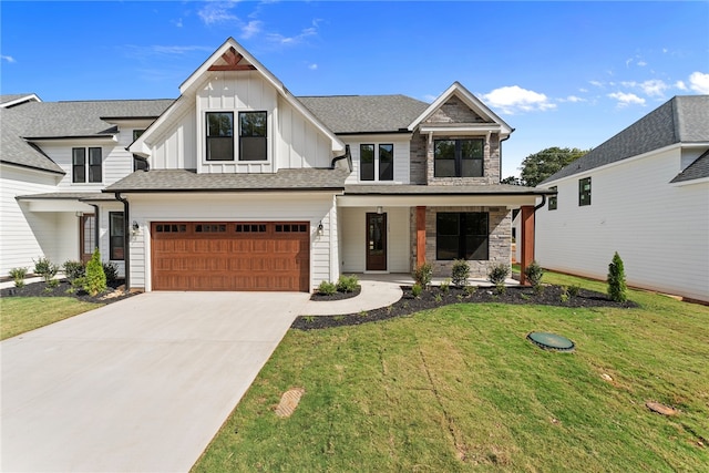 view of front of property featuring a porch, a front lawn, and a garage