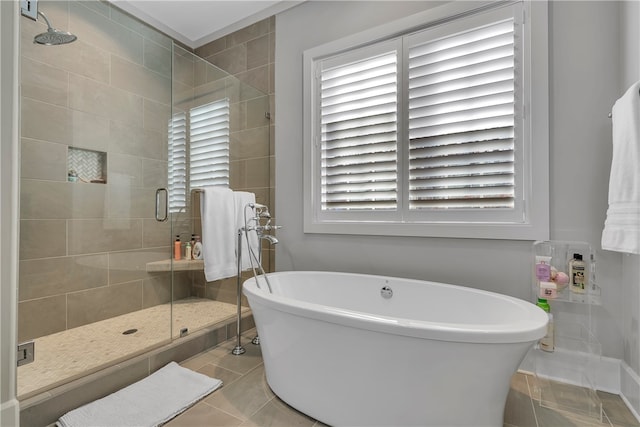 bathroom featuring separate shower and tub and tile patterned floors