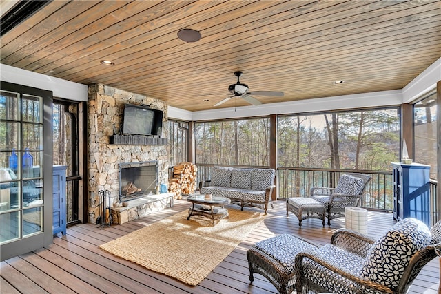 sunroom / solarium with wooden ceiling, a healthy amount of sunlight, and ceiling fan