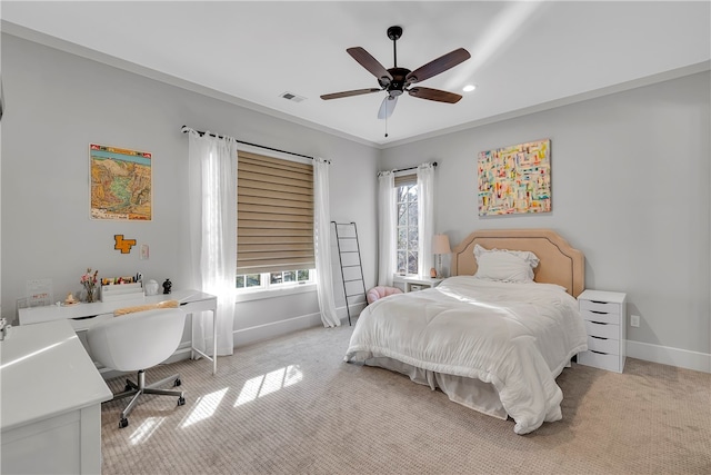 carpeted bedroom with ceiling fan, multiple windows, and crown molding