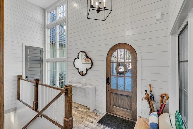 foyer featuring wood walls