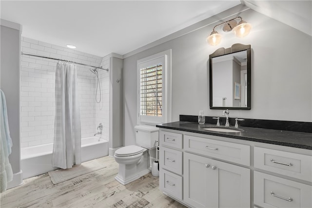 full bathroom featuring vanity, shower / bath combo with shower curtain, toilet, and hardwood / wood-style flooring