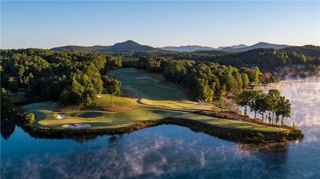 surrounding community with a water and mountain view