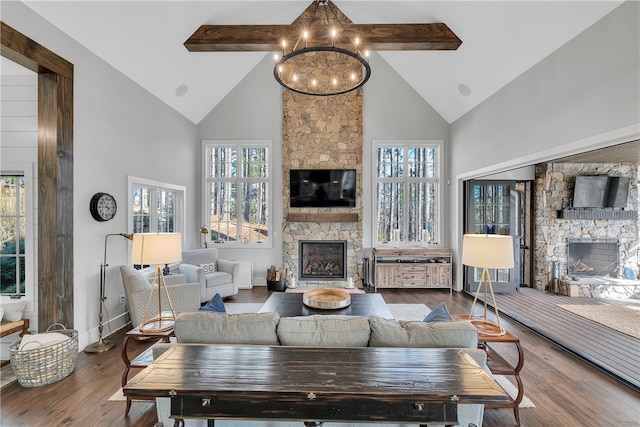 living room with a stone fireplace, beamed ceiling, and hardwood / wood-style flooring