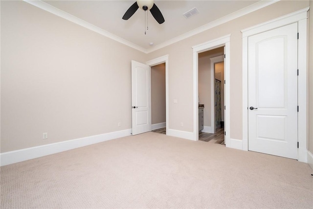 unfurnished bedroom with light carpet, baseboards, visible vents, a ceiling fan, and ornamental molding