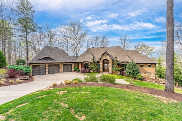 view of front of property featuring an attached garage, concrete driveway, stone siding, stucco siding, and a front lawn