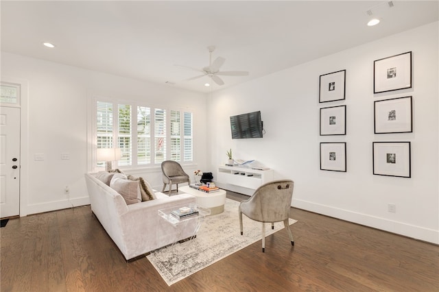 living room featuring dark hardwood / wood-style flooring and ceiling fan