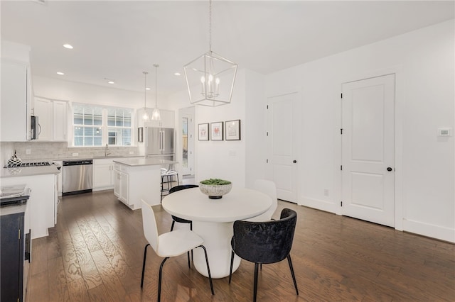 dining space featuring dark hardwood / wood-style floors and a notable chandelier