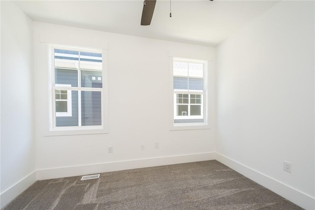1230 Melton Rd Unit 211, West Union, SC 29696 - unfurnished room with baseboards, visible vents, dark carpet, and ceiling fan
