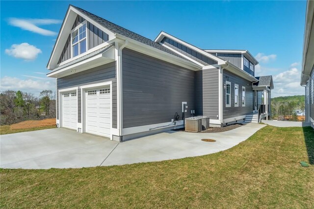 1230 Melton Rd Unit 211, West Union, SC 29696 - view of side of property with driveway, board and batten siding, central air condition unit, an attached garage, and a lawn
