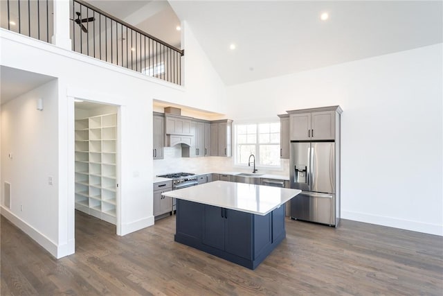 1230 Melton Rd Unit 211, West Union, SC 29696 - kitchen with a sink, stainless steel appliances, a kitchen island, baseboards, and a high ceiling