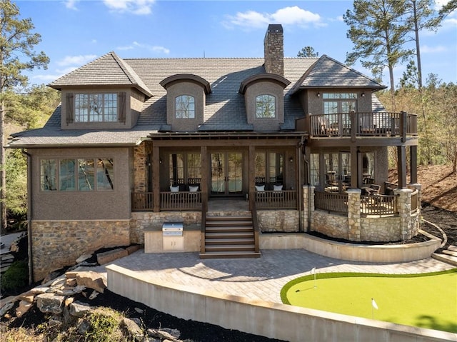 view of front facade featuring a patio area and exterior kitchen