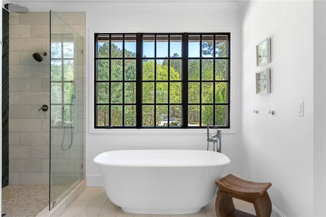 bathroom with a wealth of natural light, tile patterned flooring, and shower with separate bathtub