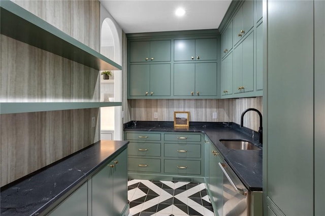 kitchen featuring sink, dark stone countertops, dishwasher, green cabinets, and light tile patterned flooring