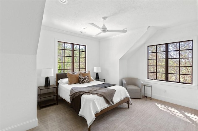 bedroom featuring a textured ceiling, ceiling fan, and lofted ceiling