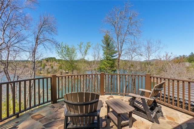 wooden terrace featuring a water view