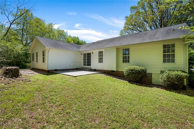 back of house featuring a patio and a yard