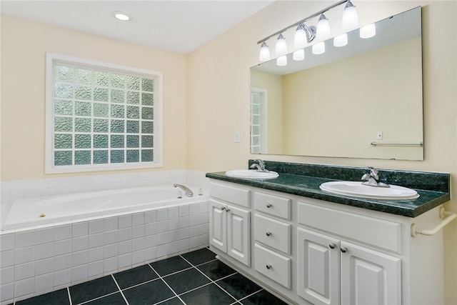 bathroom featuring vanity, a relaxing tiled tub, and tile patterned flooring