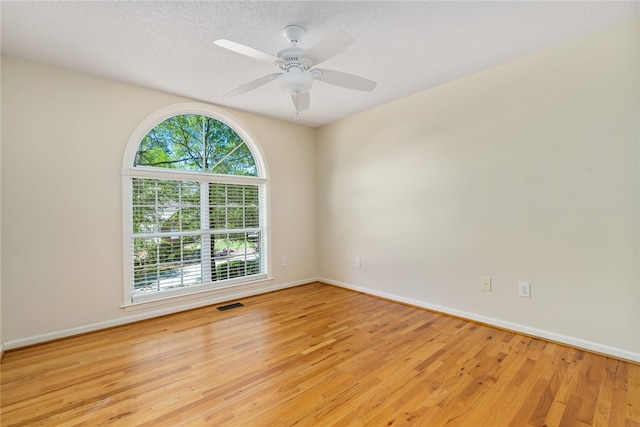 unfurnished room with light hardwood / wood-style flooring, a textured ceiling, and ceiling fan