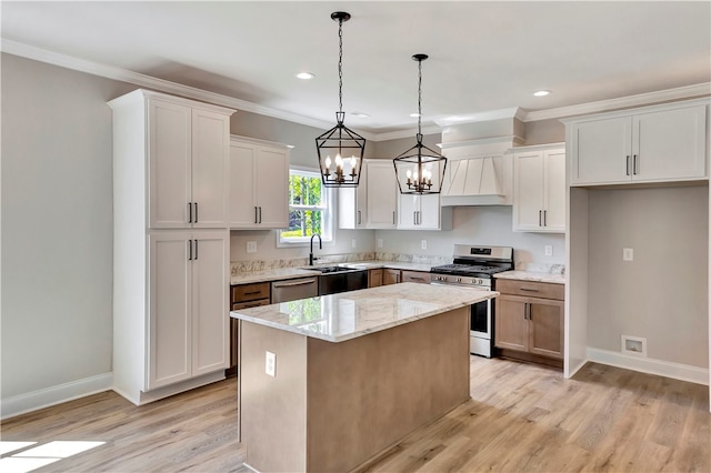 kitchen featuring appliances with stainless steel finishes, a kitchen island, and white cabinets