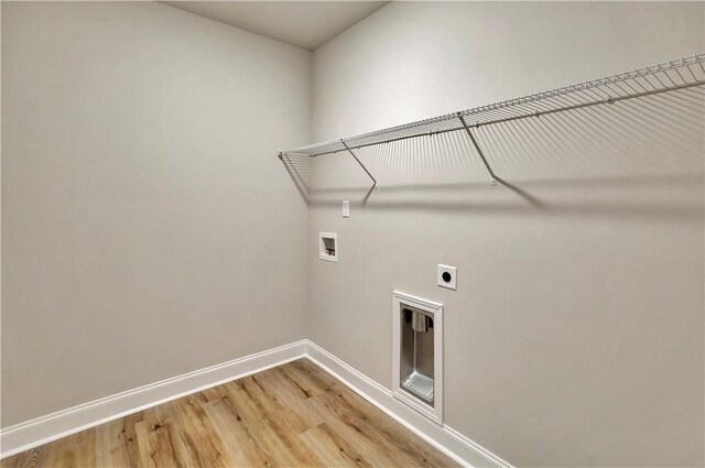 clothes washing area featuring washer hookup, wood-type flooring, and electric dryer hookup