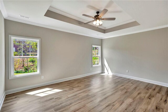 unfurnished room with light hardwood / wood-style flooring, ceiling fan, plenty of natural light, and crown molding