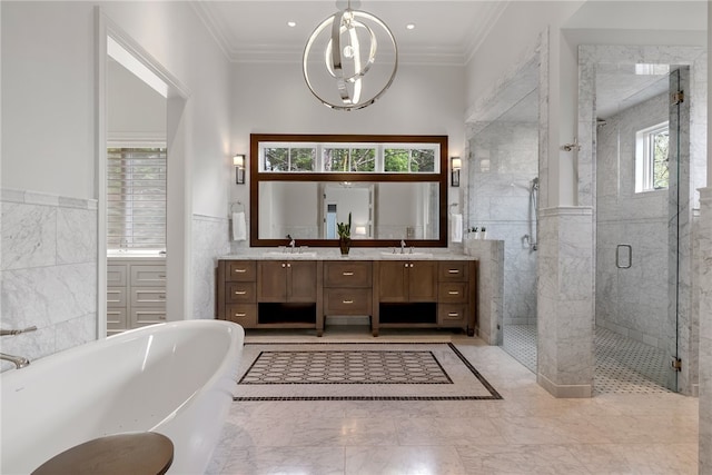 bathroom featuring tile walls, vanity, plus walk in shower, and ornamental molding