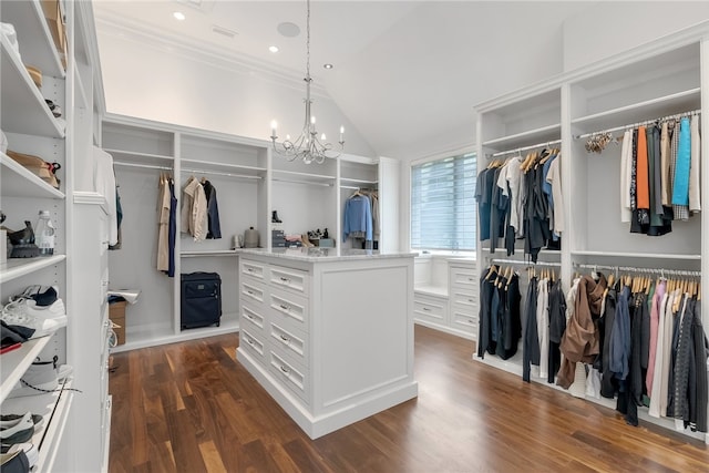 spacious closet with a chandelier, vaulted ceiling, and dark hardwood / wood-style flooring