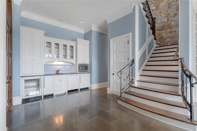 interior space featuring ornamental molding and sink