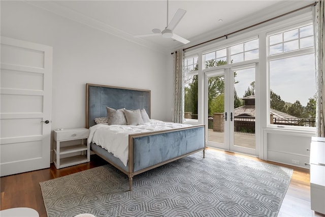 bedroom with access to outside, hardwood / wood-style floors, french doors, and crown molding