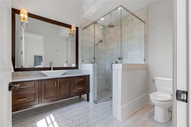 bathroom with toilet, a shower with shower door, and vanity