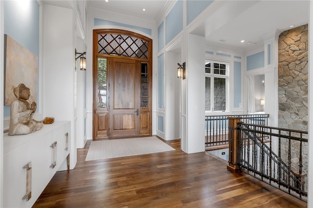 entrance foyer featuring a high ceiling, crown molding, and dark hardwood / wood-style flooring