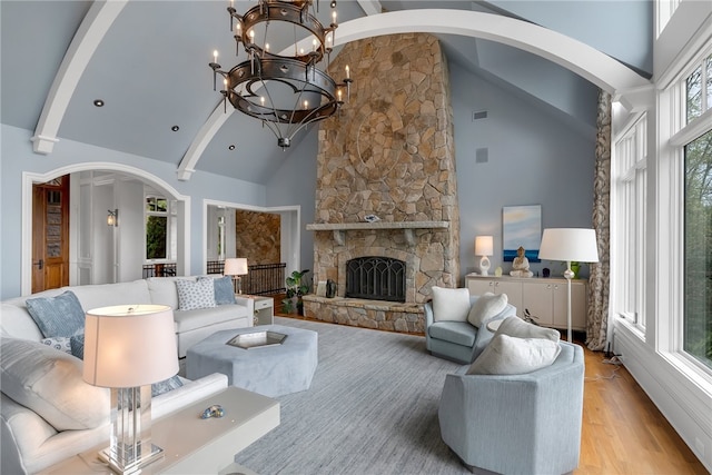 living room with high vaulted ceiling and a wealth of natural light