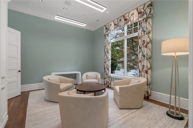 living area featuring ornamental molding and hardwood / wood-style floors