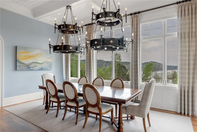 dining room featuring an inviting chandelier, hardwood / wood-style floors, and beamed ceiling