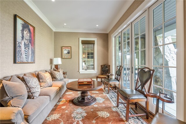 living room with french doors, crown molding, and hardwood / wood-style floors