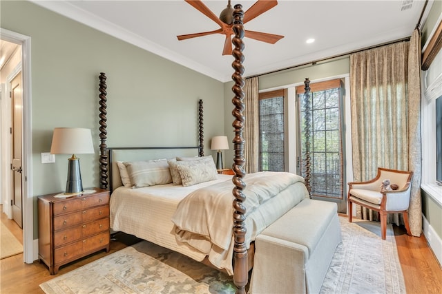 bedroom with crown molding, light hardwood / wood-style floors, ceiling fan, and access to exterior