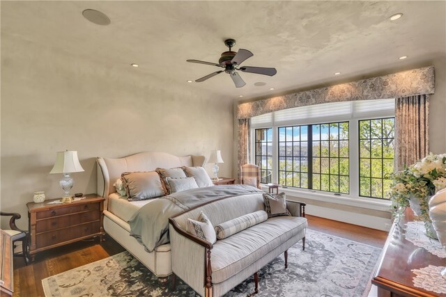 bedroom featuring ceiling fan and dark hardwood / wood-style flooring