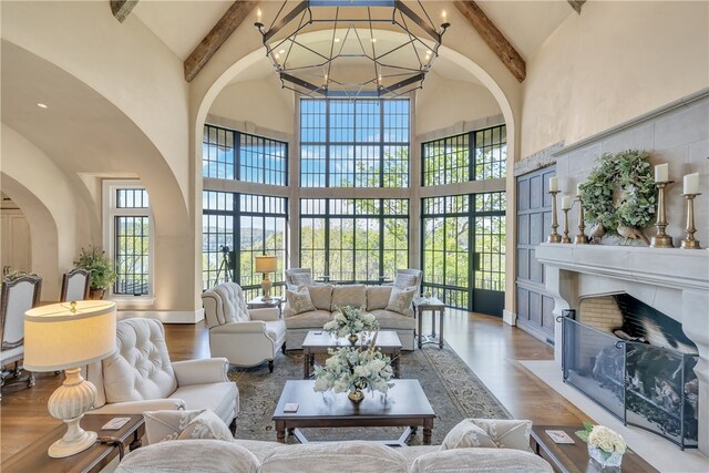 living room with high vaulted ceiling and beamed ceiling