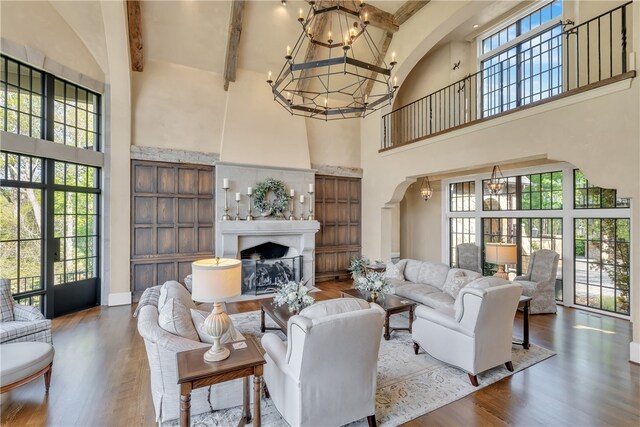 living room with beam ceiling, high vaulted ceiling, and a wealth of natural light