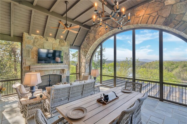 unfurnished sunroom with a healthy amount of sunlight, vaulted ceiling with beams, and wooden ceiling